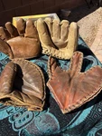 4 Vintage Baseball Mitts- Page Setter, Nokona, First Baseman Glove & The Trapper. Fixed Price $189.99.