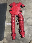 Rawlings Mach Adjustable Red Baseball Catcher Chest Protector & Leg Guards Set. Fixed Price $550.00.